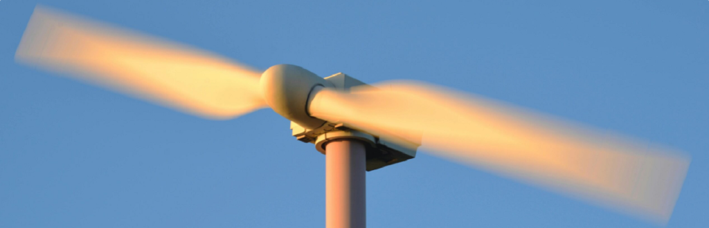 Close-up of a wind turbine blade in motion, illustrating efforts in increasing renewable energy asset performance.